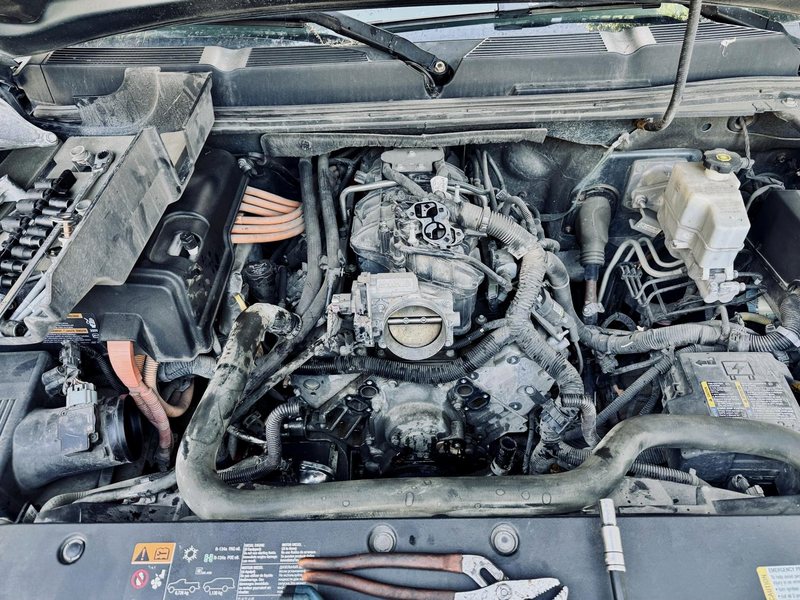 Chevy Silverado engine bay during a water pump and thermostat replacement by Farrell's Automotive