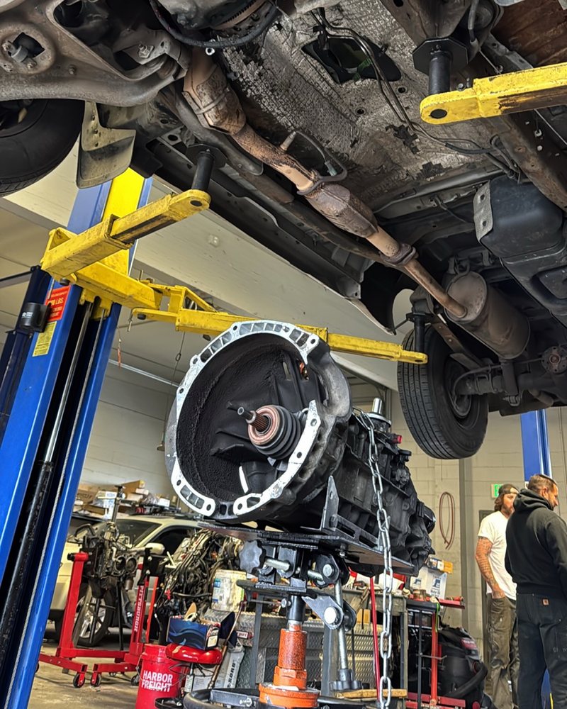 Transmission lowered on a transmission jack during a Ford Ranger clutch job by Farrell's Automotive